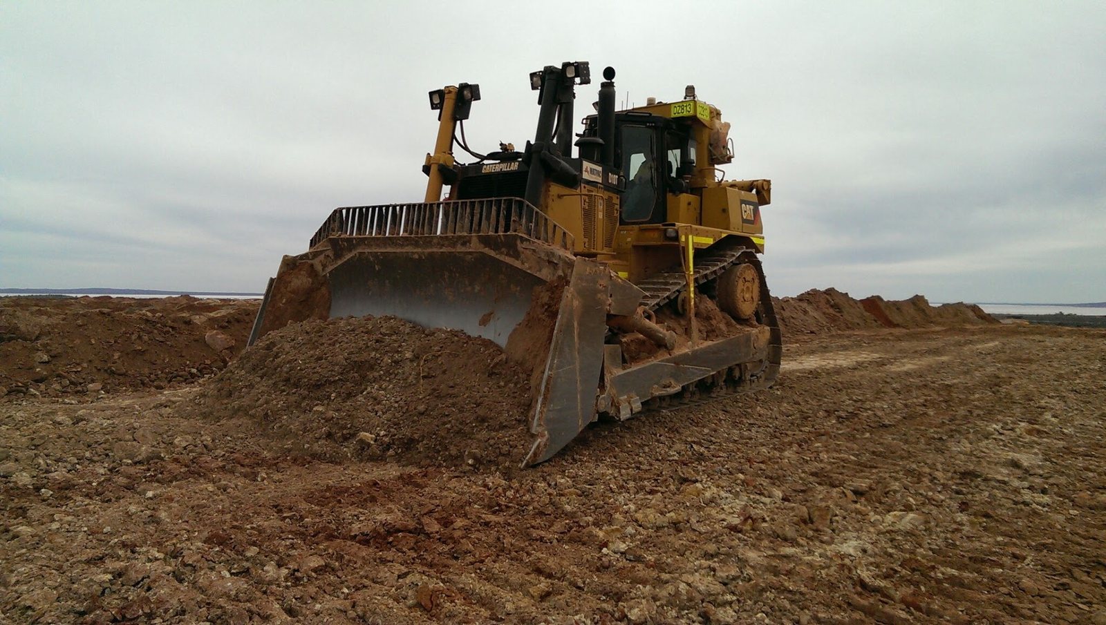 Dozer carrying out bulk pushing and batter shaping works