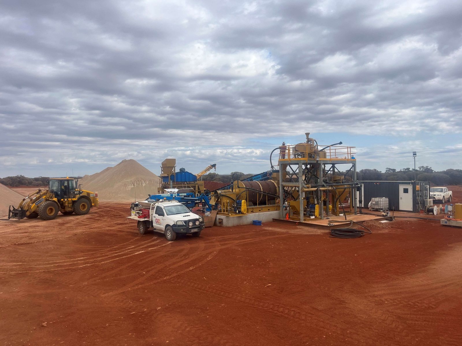 Processing plant and mobile equipment on a red earth mining site in regional Western Australia